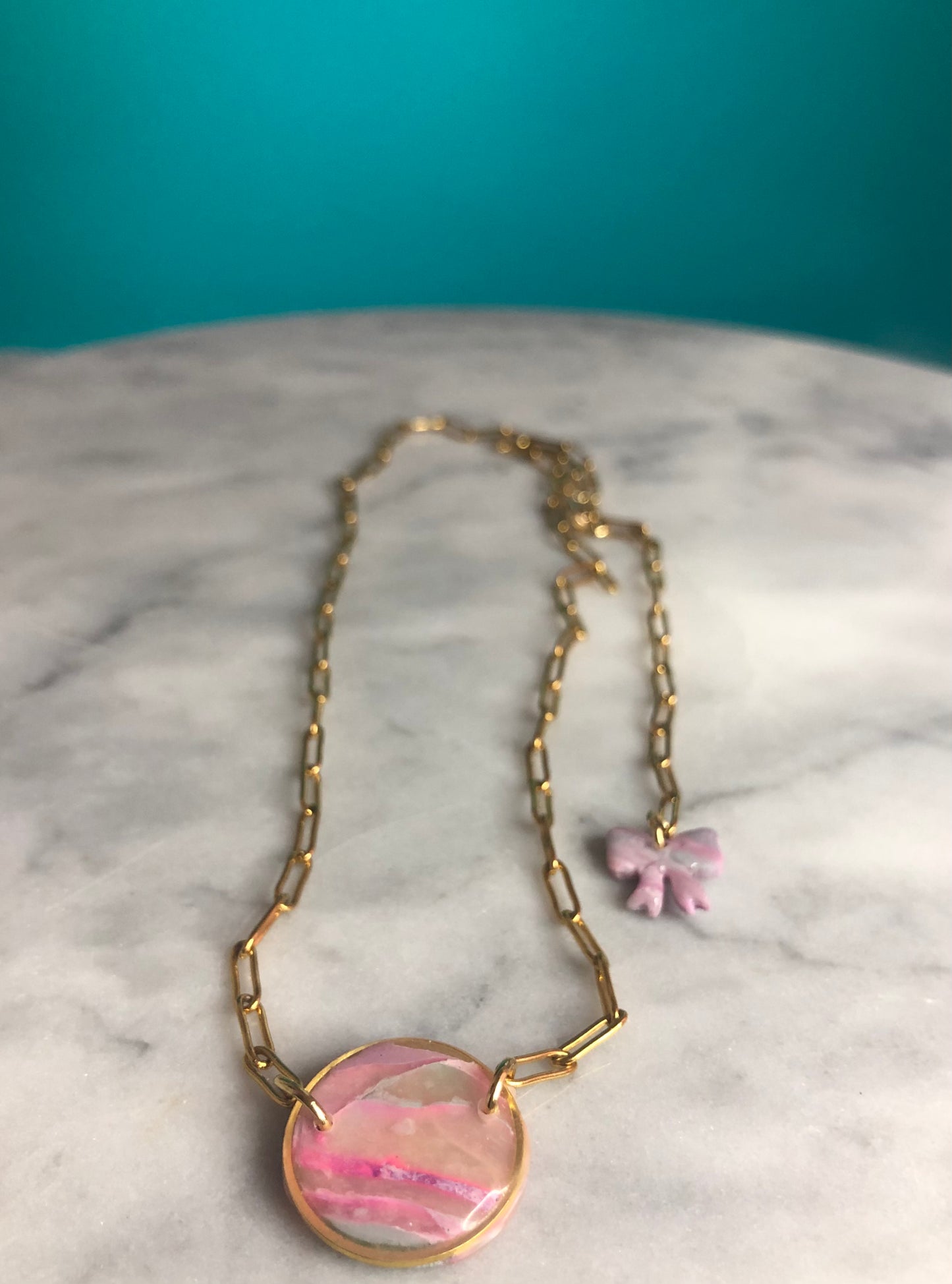 Pretty in Pink- Stainless Steel gold plated paper clip necklace with marbled clay resin glazed circle.